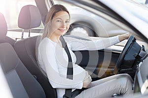 Pregnant woman driving her car