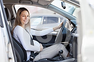 Pregnant woman driving her car