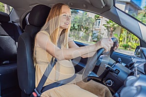 Pregnant woman driving with safety belt on in the car. Confident and capable, a pregnant woman takes the wheel, driving