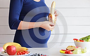 Pregnant woman eat vegetable salad, fruit, healthy food
