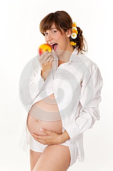 Pregnant woman eating an apple