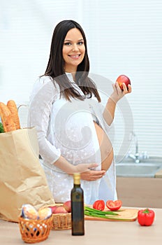 Pregnant woman eating the apple