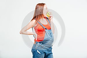 Pregnant woman eating apple