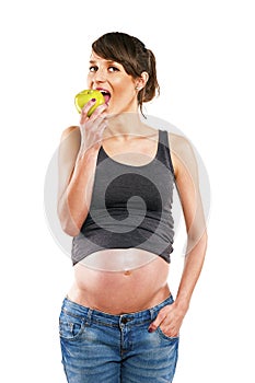 Pregnant woman eating apple isolated