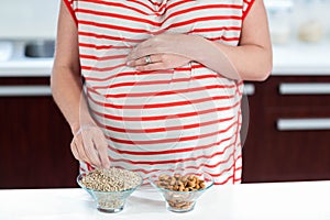 Pregnant woman eating cereals