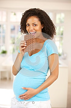 Pregnant woman eating chocolate