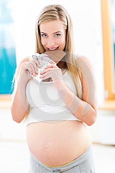 Pregnant woman eating chocolate