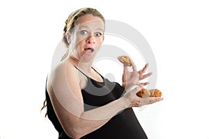 Pregnant woman eating fast food, croissant, too much isolated