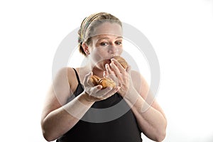 Pregnant woman eating fast food, croissant, too much isolated