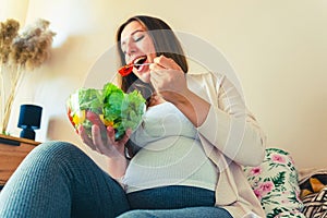 Pregnant woman eating healthy food. Happy pregnancy mother eating nutrition diet salad. Healthy breakfast food concept.