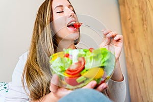 Pregnant woman eating healthy food. Happy pregnancy mother eating nutrition diet salad. Healthy breakfast food concept.