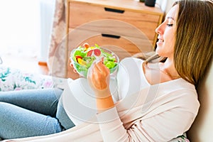Pregnant woman eating healthy food. Happy pregnancy mother eating nutrition diet salad. Healthy breakfast food concept.