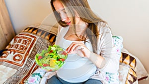 Pregnant woman eating healthy food. Happy pregnancy mother eating nutrition diet salad. Healthy breakfast food concept.