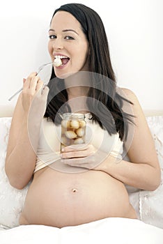 Pregnant woman eating pickled onions