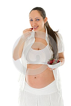 Pregnant woman eating strawberries