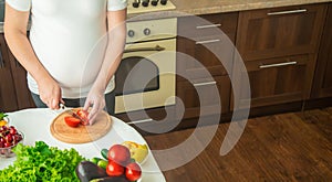 A pregnant woman eats vegetables and fruits. Selective focus