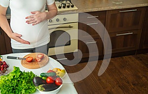 A pregnant woman eats vegetables and fruits. Selective focus