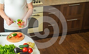 A pregnant woman eats vegetables and fruits. Selective focus