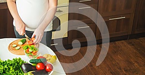 A pregnant woman eats vegetables and fruits. Selective focus