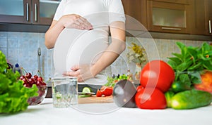 A pregnant woman eats vegetables and fruits. Selective focus