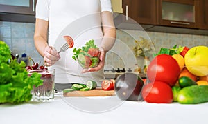 A pregnant woman eats vegetables and fruits. Selective focus