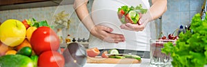 A pregnant woman eats vegetables and fruits. Selective focus.