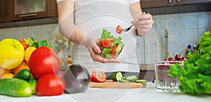 A pregnant woman eats vegetables and fruits. Selective focus.