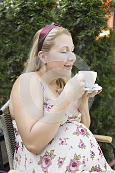 Pregnant woman enjoying cofee