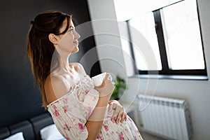 Pregnant woman enjoying cup of coffee or tea