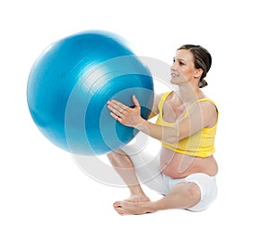 Pregnant woman excercises with a gymnastic ball