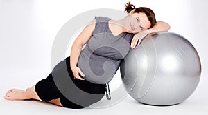 Pregnant woman excercises with gymnastic ball