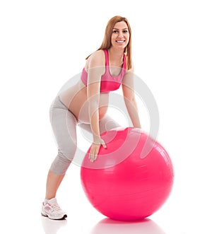 Pregnant woman exercise and limbering with ball