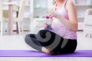 The pregnant woman exercising in anticipation of child birth