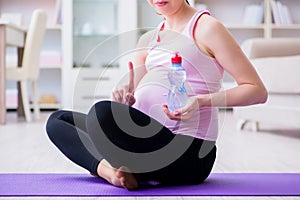 The pregnant woman exercising in anticipation of child birth