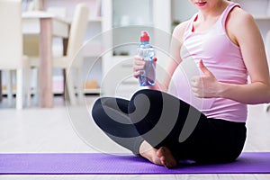 The pregnant woman exercising in anticipation of child birth