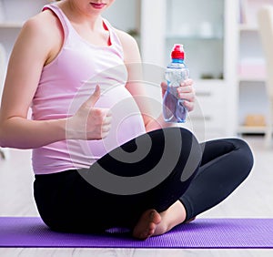 Pregnant woman exercising in anticipation of child birth