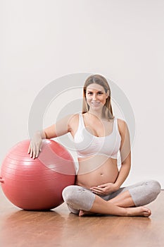 Pregnant woman exercising with ball