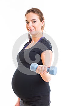 Pregnant woman exercising with dumbbells