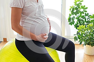 Pregnant woman exercising at home