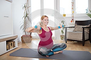 Pregnant woman exercising at home