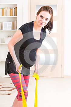 Pregnant woman exercising at home