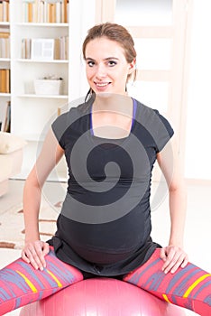 Pregnant woman exercising at home