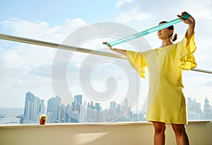 Pregnant Woman Exercising With Rubber Band At Home