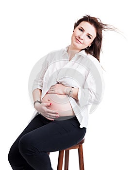 Pregnant woman expecting a baby, smiling and touching her belly
