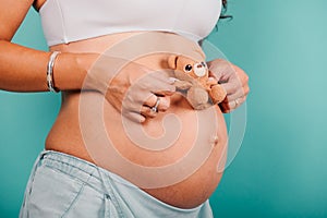 Pregnant woman expecting a child caresses her belly