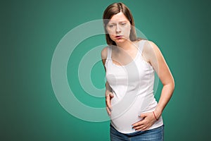 Pregnant woman feeling pain in the back and in the belly, contractions begin.