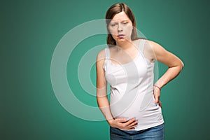 Pregnant woman feeling pain in the back and in the belly, contractions begin.