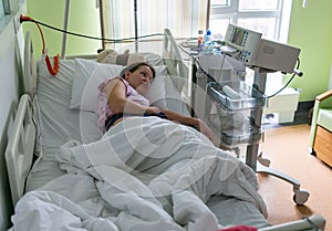Pregnant woman feels hard contraction in a hospital labor delivery room. Concept photo of pregnancy, pregnant woman