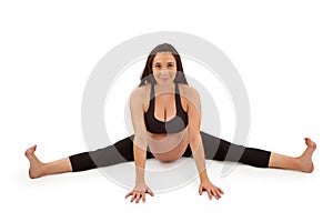 Pregnant woman in forward fold yoga pose