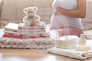 Pregnant woman is getting ready for the maternity hospital, packing baby stuff. pregnant woman preparing and planning baby clothes